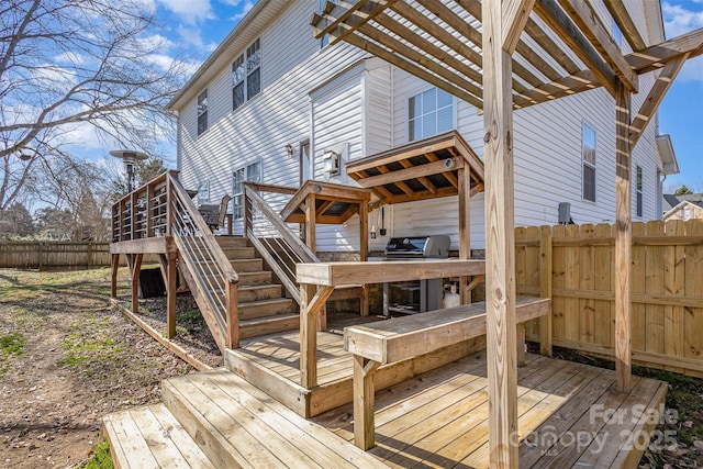 wooden deck with stairway, grilling area, and fence