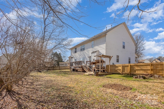 rear view of house with a fenced backyard, a yard, a deck, and a pergola