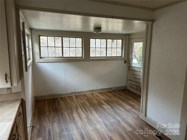 unfurnished room with dark wood-type flooring