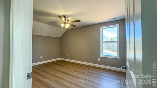 additional living space featuring lofted ceiling, light hardwood / wood-style flooring, and ceiling fan