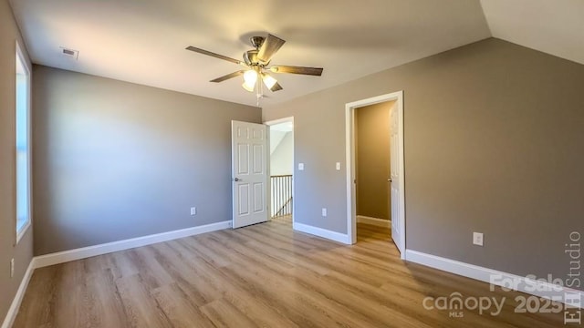 unfurnished bedroom featuring vaulted ceiling, ceiling fan, and light hardwood / wood-style floors