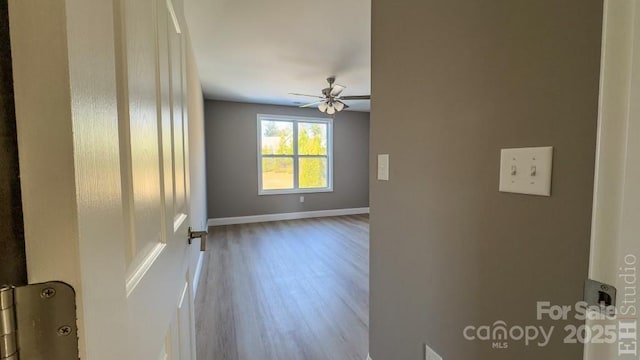 empty room with hardwood / wood-style floors and ceiling fan