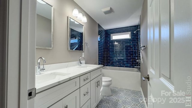 full bathroom featuring tiled shower / bath combo, vanity, tile patterned floors, and toilet