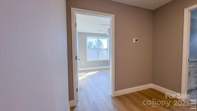 corridor with light hardwood / wood-style floors