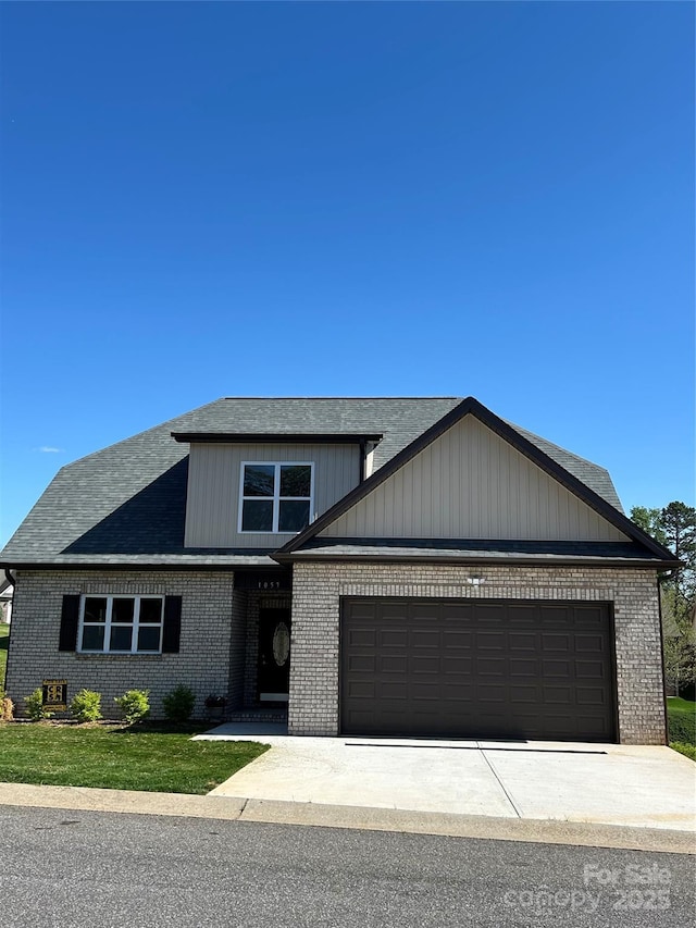 view of front of property featuring an attached garage, driveway, and brick siding