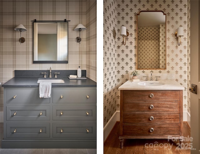 bathroom featuring a sink, two vanities, and wallpapered walls