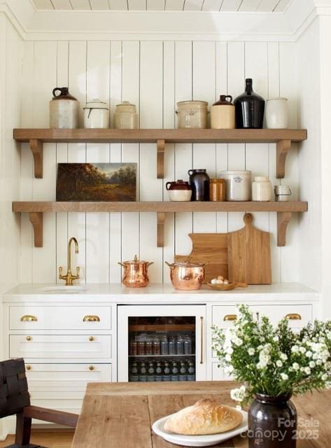 interior space featuring a sink and beverage cooler