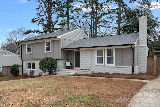 tri-level home with a front lawn