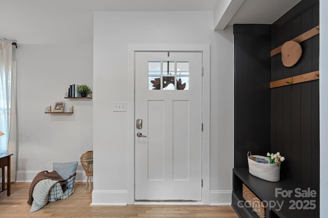 foyer entrance with light hardwood / wood-style floors