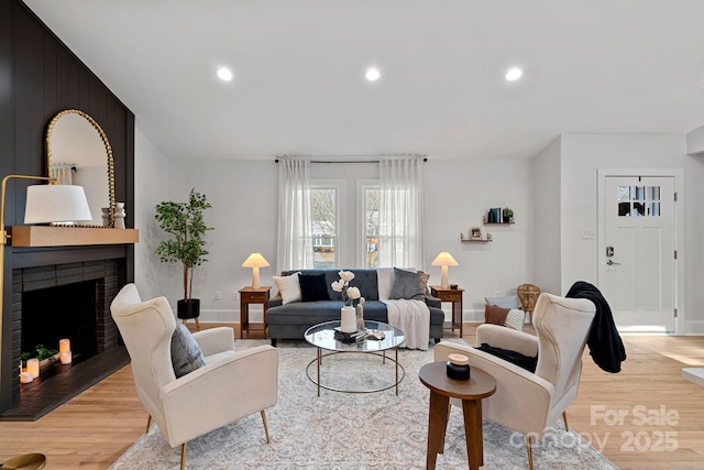 living room with a fireplace and light hardwood / wood-style floors