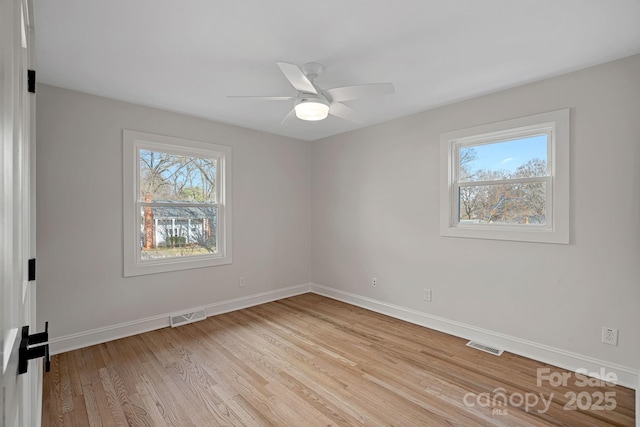 unfurnished room with ceiling fan and light wood-type flooring