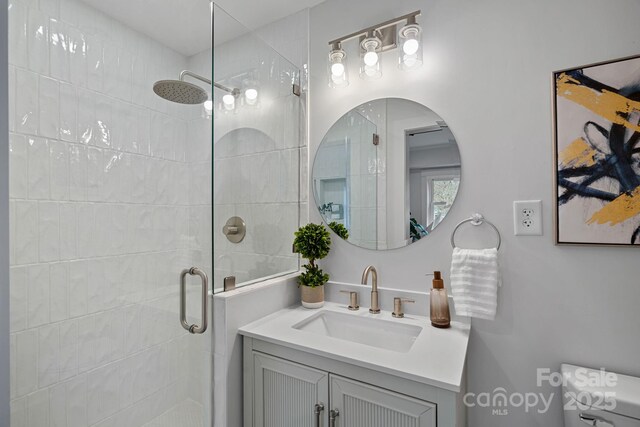 bathroom featuring vanity and an enclosed shower