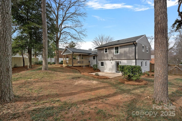 back of property featuring a yard and a patio