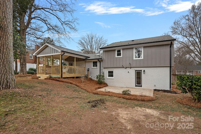 back of property with a patio area and a lawn