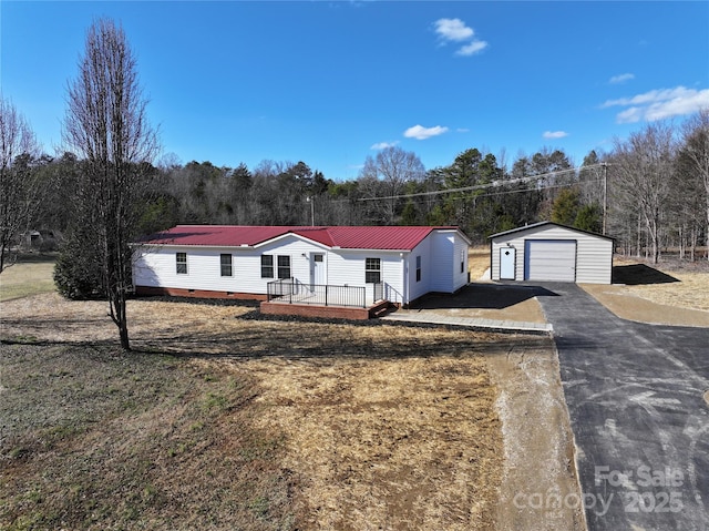 manufactured / mobile home featuring a garage and an outbuilding