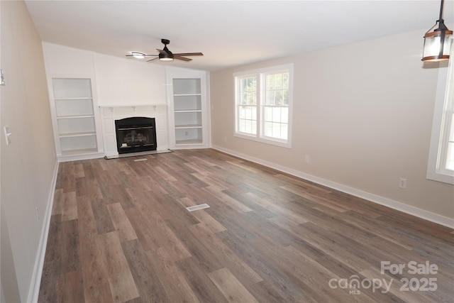 unfurnished living room with hardwood / wood-style flooring and ceiling fan