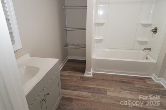 bathroom with vanity, hardwood / wood-style flooring, and shower / bath combination