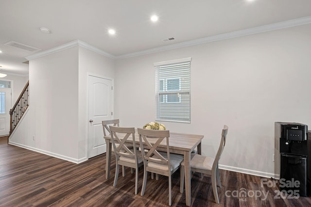 dining area with crown molding and dark hardwood / wood-style flooring