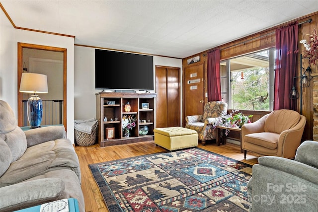 living room featuring ornamental molding and light wood-type flooring