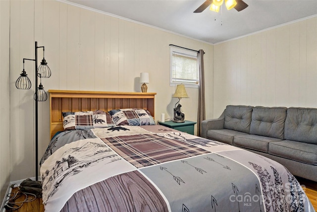 bedroom featuring ornamental molding, wood-type flooring, and ceiling fan