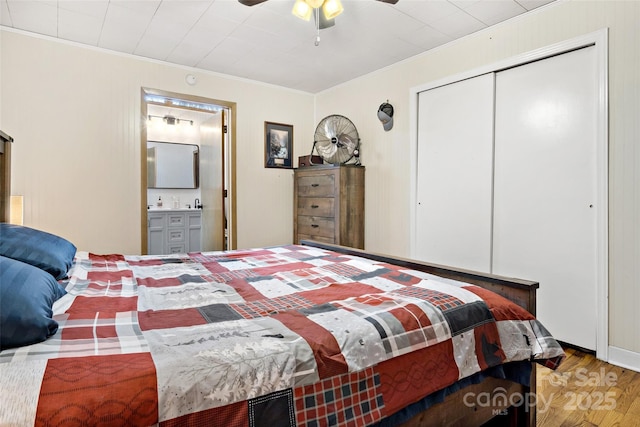 bedroom featuring ceiling fan, a closet, ornamental molding, and light hardwood / wood-style flooring