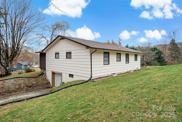 view of home's exterior with a garage and a yard