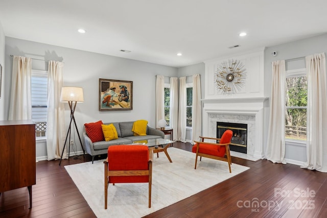 living room with a premium fireplace and dark hardwood / wood-style floors