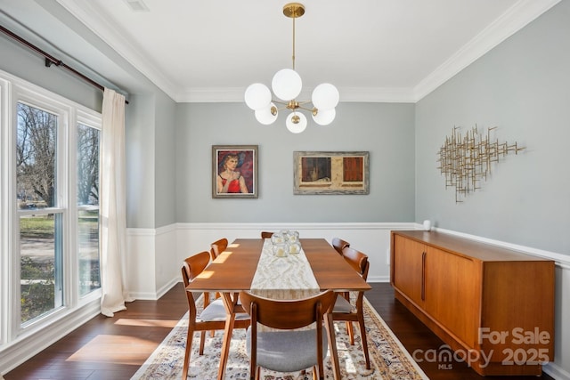 dining space featuring crown molding, dark hardwood / wood-style floors, a wealth of natural light, and an inviting chandelier