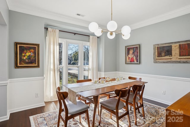 dining area featuring a notable chandelier, crown molding, and dark hardwood / wood-style floors