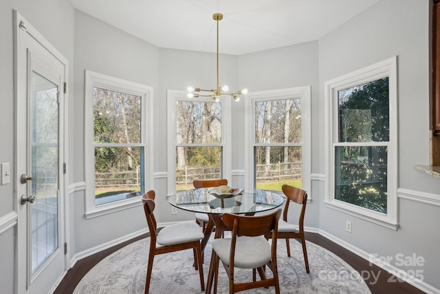 sunroom with a wealth of natural light and a chandelier