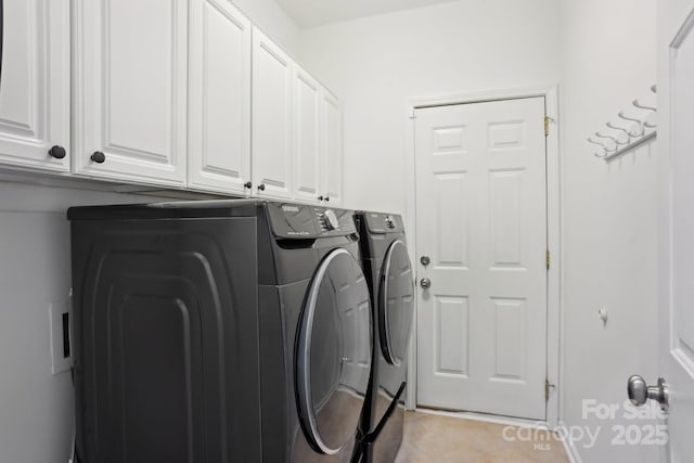 washroom featuring cabinets, washer and dryer, and light tile patterned floors