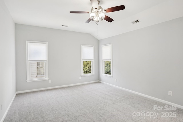 carpeted empty room featuring ceiling fan and vaulted ceiling