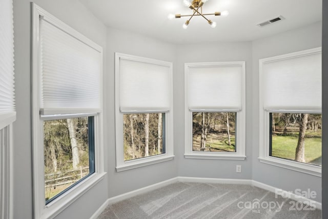 unfurnished sunroom featuring a chandelier