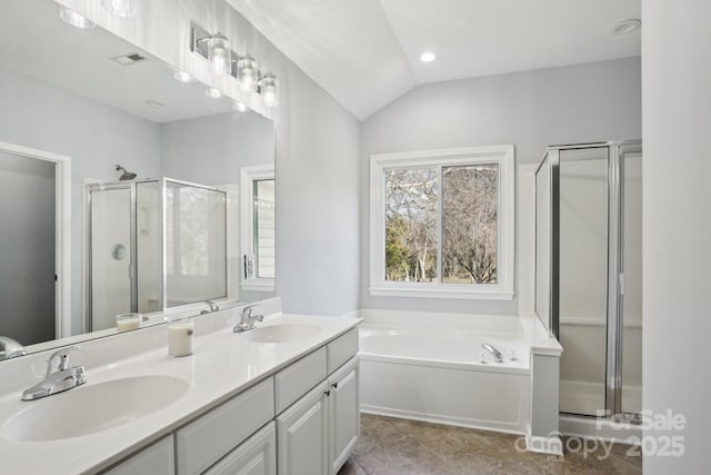 bathroom featuring plus walk in shower, lofted ceiling, and vanity