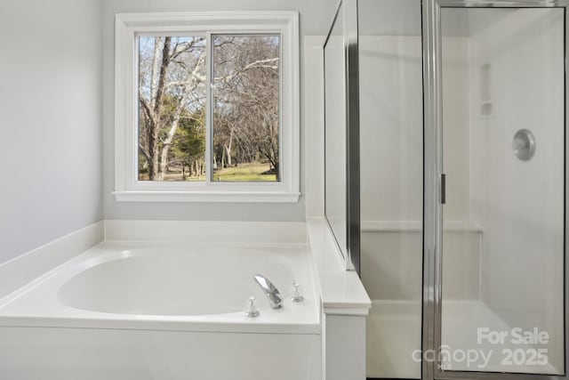 bathroom with separate shower and tub