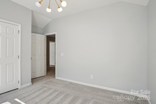 unfurnished bedroom with lofted ceiling, light carpet, and a chandelier