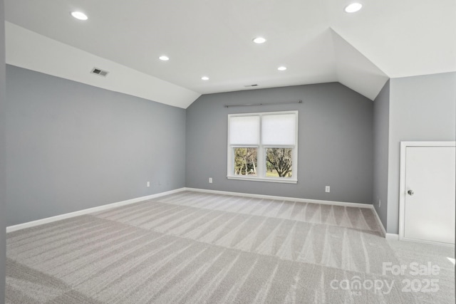 bonus room featuring vaulted ceiling and light carpet