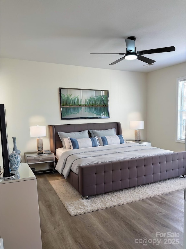 bedroom featuring dark wood-style floors and ceiling fan