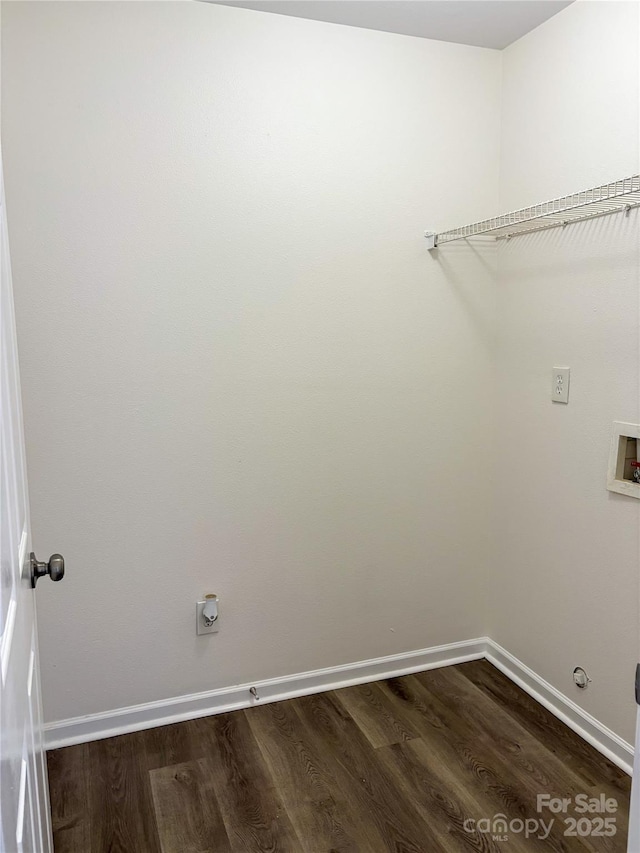 laundry area with washer hookup, laundry area, baseboards, and wood finished floors