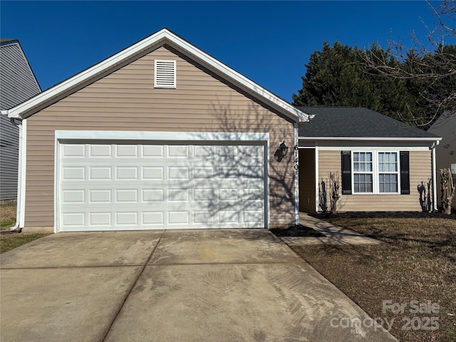 single story home featuring a garage and concrete driveway