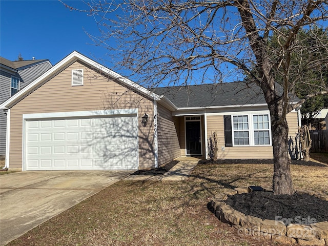 single story home featuring a garage and driveway