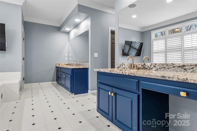 bathroom featuring ornamental molding, a tub, and vanity