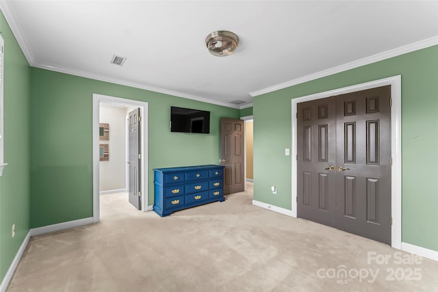 unfurnished bedroom featuring crown molding, light carpet, and a closet