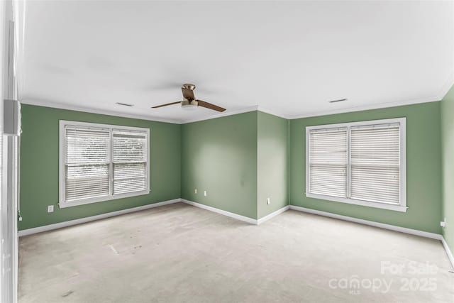 unfurnished room featuring crown molding, ceiling fan, and light carpet