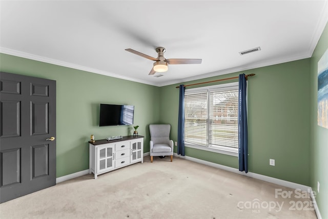 sitting room featuring crown molding, light colored carpet, and ceiling fan