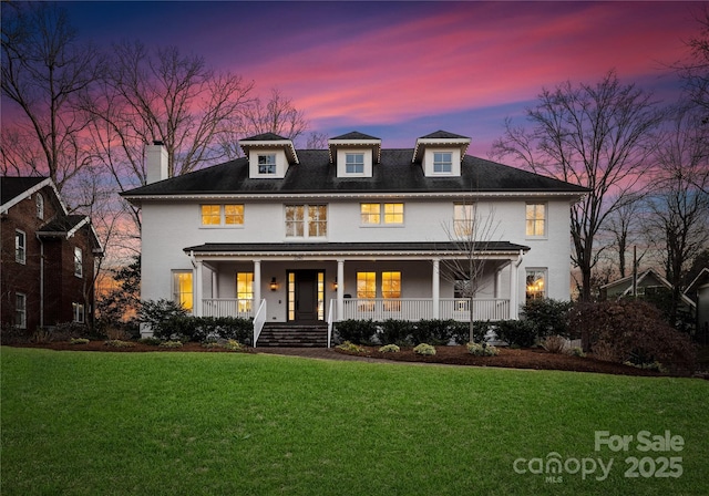 view of front of home featuring a porch and a yard