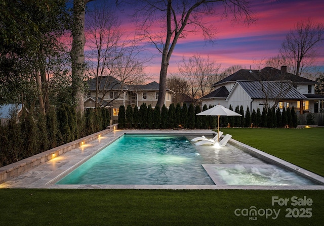 pool at dusk with a lawn