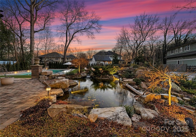 view of property's community featuring a pool and a patio area