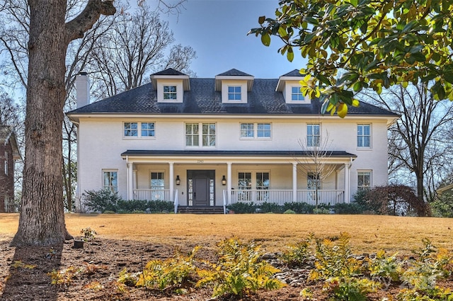 view of front of home featuring a front yard and a porch