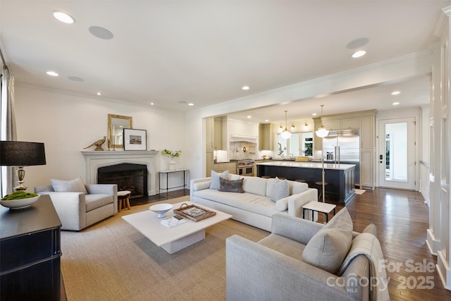 living room with ornamental molding and light hardwood / wood-style floors